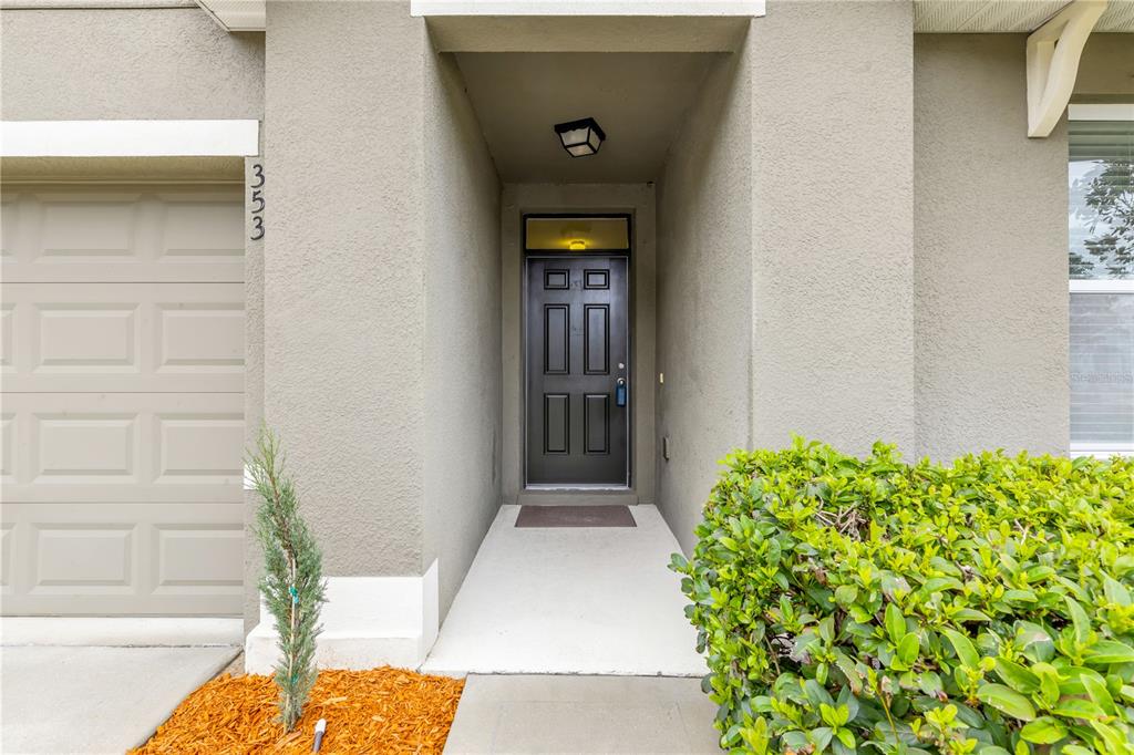 353 Admiralty Court Edgewater, FL 32141 - Photo 4 of 56 a front view of a house with a yard
