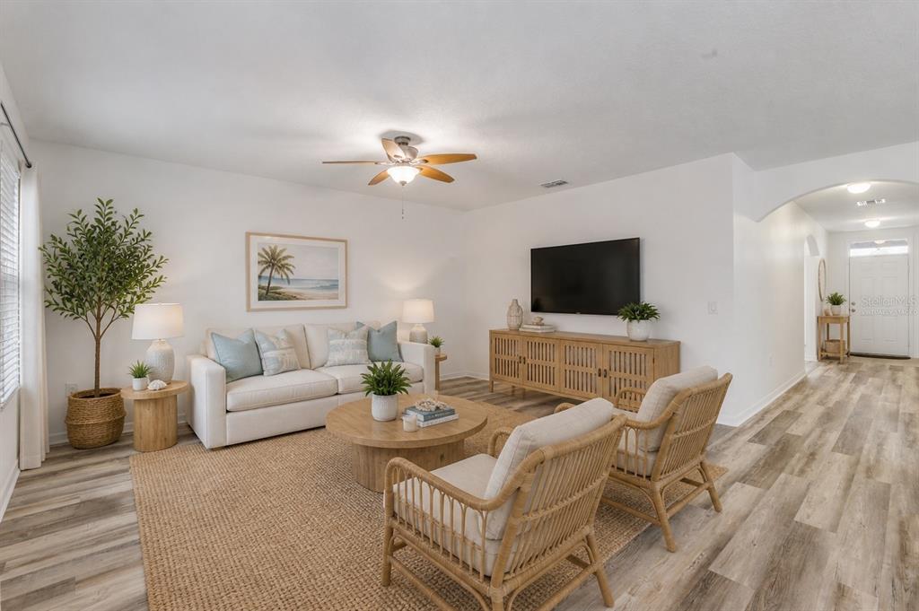 353 Admiralty Court Edgewater, FL 32141 - Photo 5 of 56 a living room with furniture and a flat screen tv