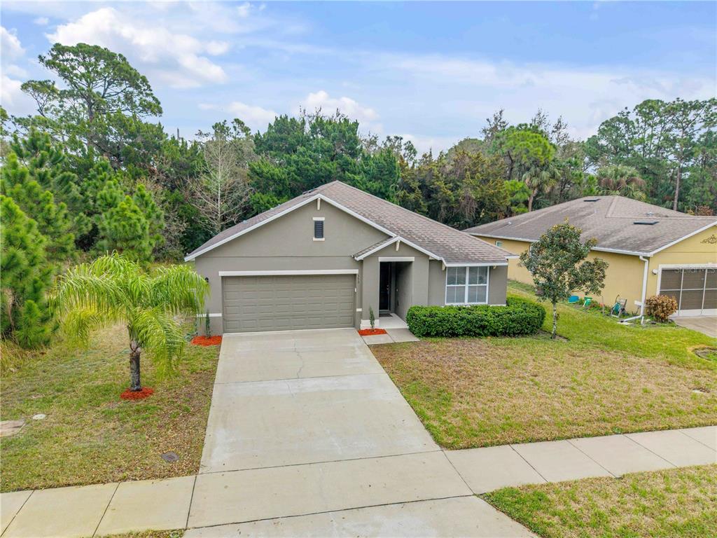 353 Admiralty Court Edgewater, FL 32141 - Photo 54 of 56 a front view of a house with a yard and potted plants