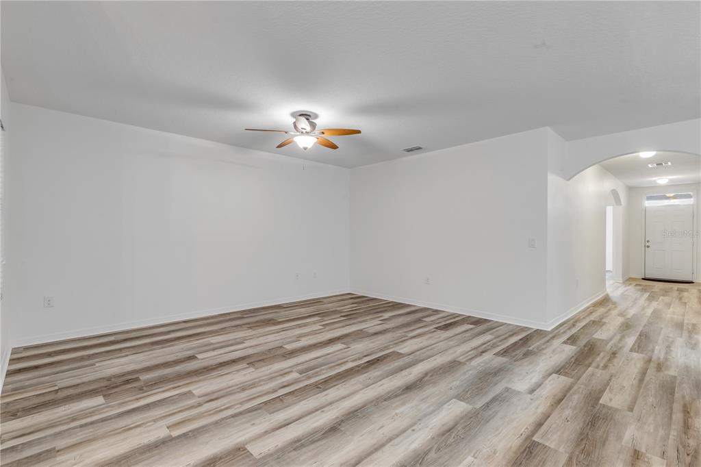 353 Admiralty Court Edgewater, FL 32141 - Photo 6 of 56 a view of empty room with wooden floor