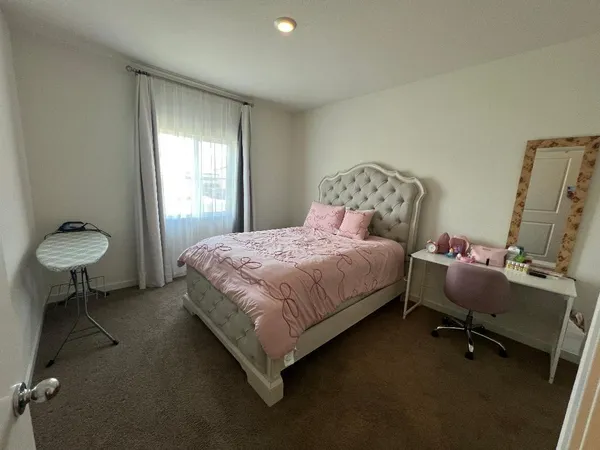 a bedroom with a bed and a table