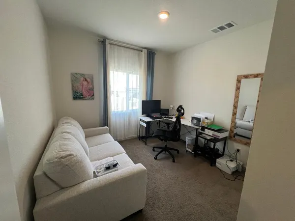 a living room with furniture and a window