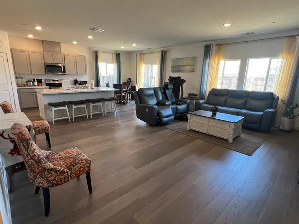 a living room with furniture and kitchen view