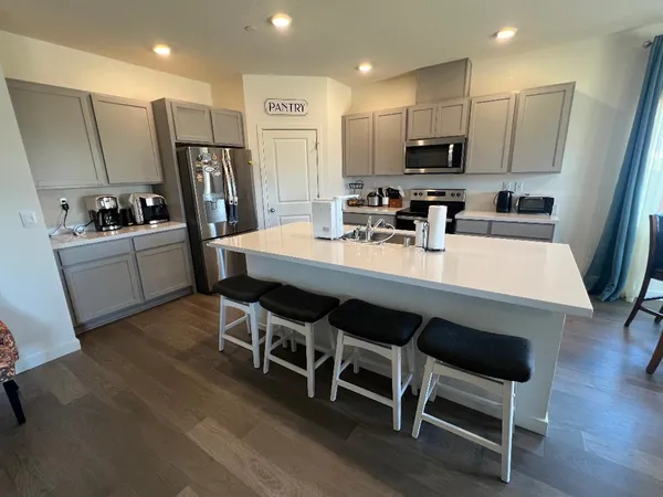 a large kitchen with a table and chairs
