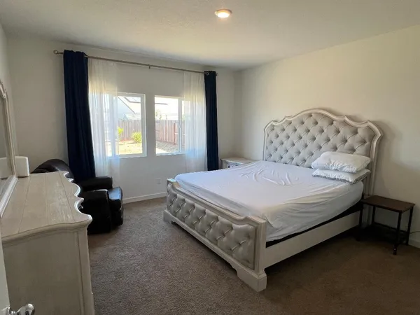 a bedroom with a bed and a couch