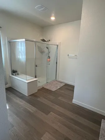 a bathroom with a tub and shower