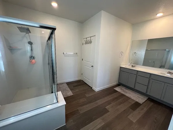 a bathroom with a double vanity sink and mirror