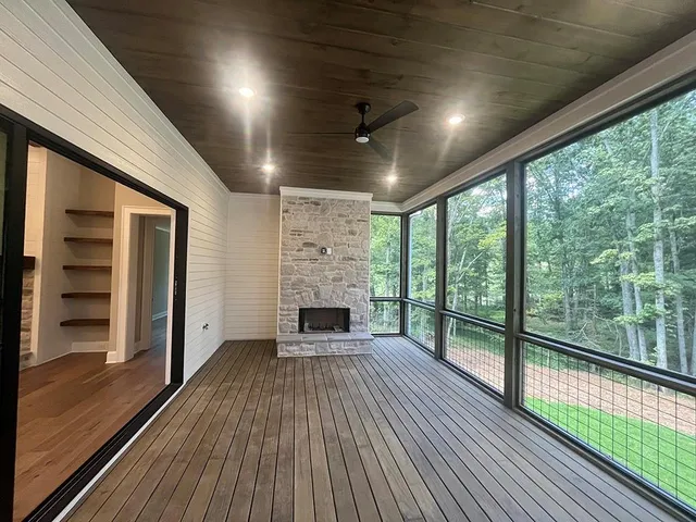a view of a livingroom with wooden floor and a ceiling fan