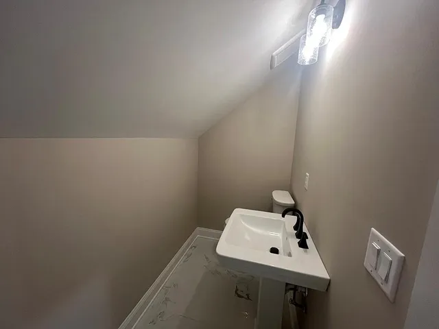 a view of empty room with floor to ceiling window and fireplace