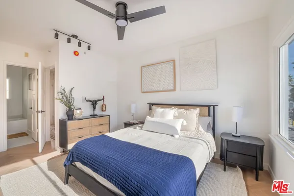 a kitchen with stainless steel appliances granite countertop a refrigerator a sink a stove and a window