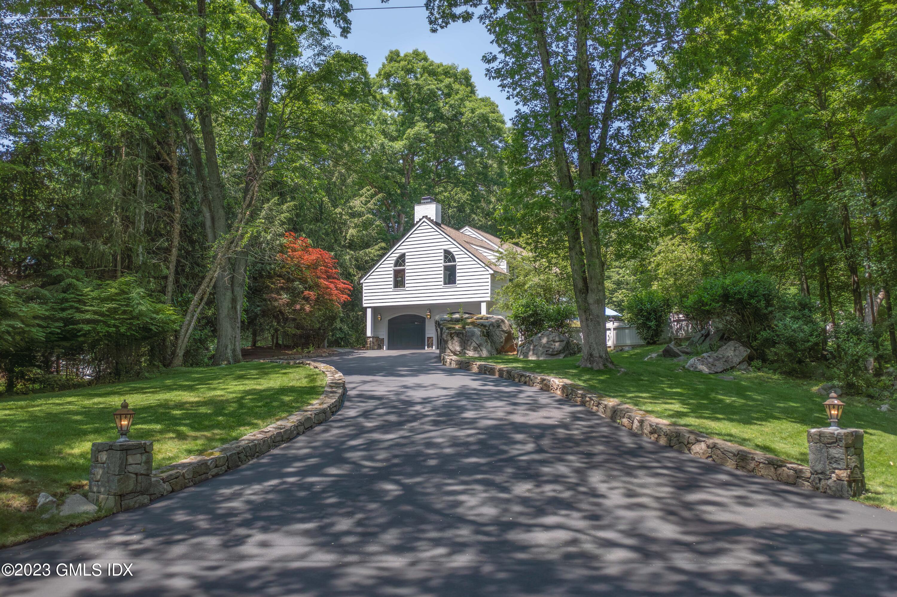 29 Indian Mill Road Cos Cob, CT 06807 - Photo 3 of 44 a front view of a house with a garden