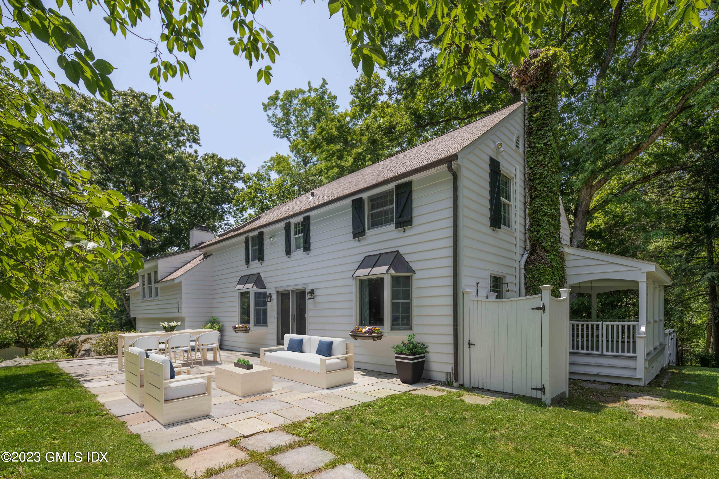 29 Indian Mill Road Cos Cob, CT 06807 - Photo 37 of 44 a view of a white house with a big yard potted plants and large tree