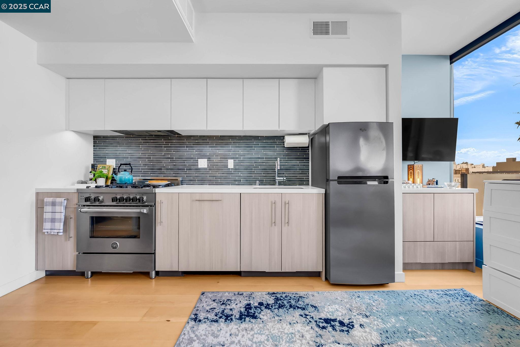 1515 15th Street, Unit 501 San Francisco, CA 94103 - Photo 13 of 46 a kitchen with a refrigerator sink and stove