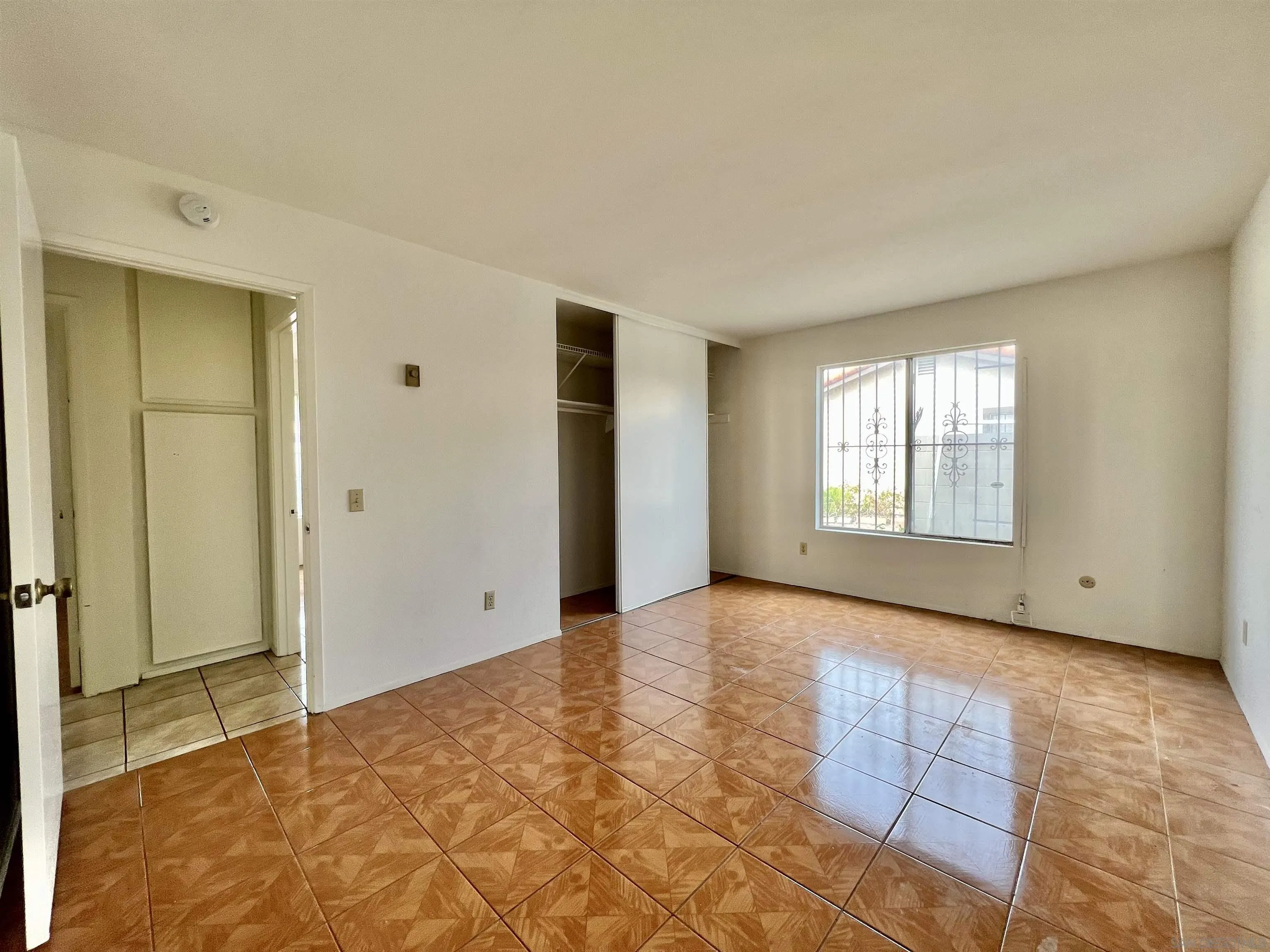 444 Bluffview Road Spring Valley, CA 91977 - Photo 17 of 34 a view of an empty room with window and wooden floor