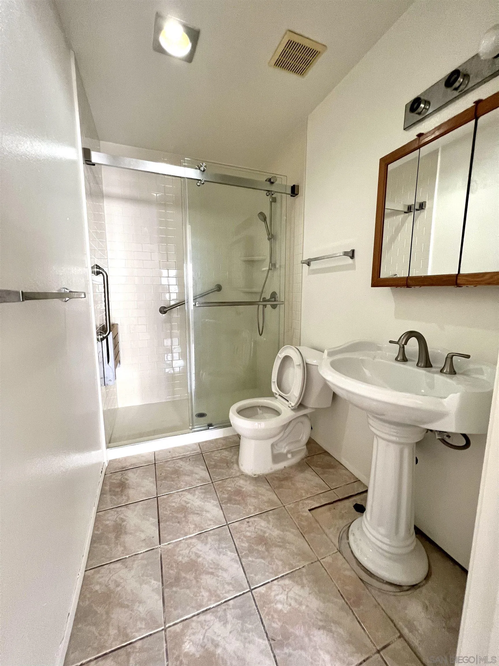 444 Bluffview Road Spring Valley, CA 91977 - Photo 20 of 34 a bathroom with a sink toilet and shower