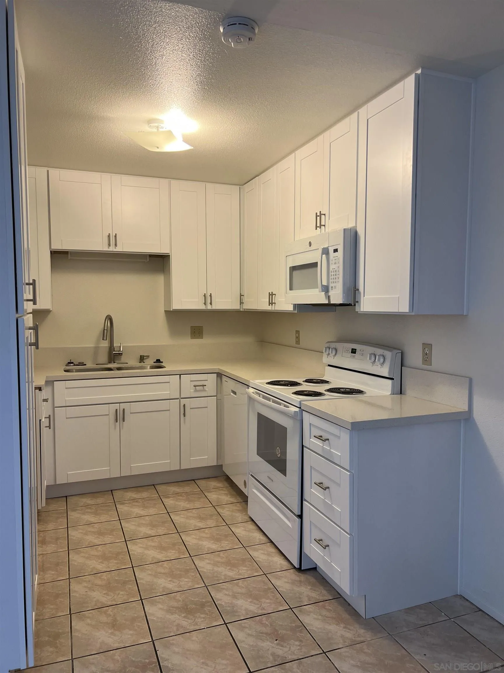 444 Bluffview Road Spring Valley, CA 91977 - Photo 23 of 34 a kitchen with a stove sink and cabinets