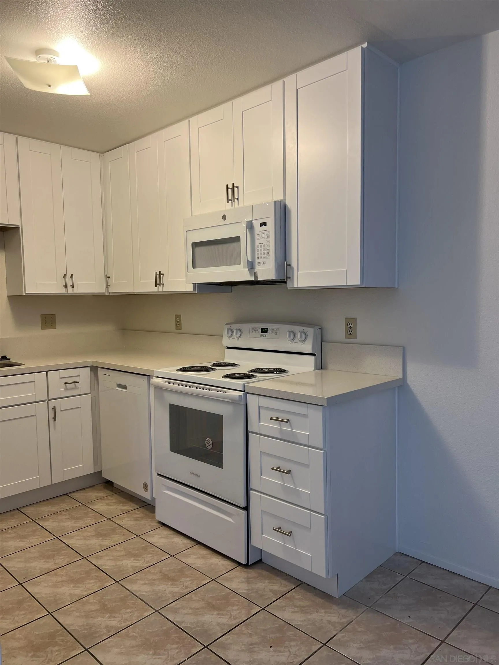 444 Bluffview Road Spring Valley, CA 91977 - Photo 24 of 34 a kitchen with stainless steel appliances granite countertop a sink and cabinets