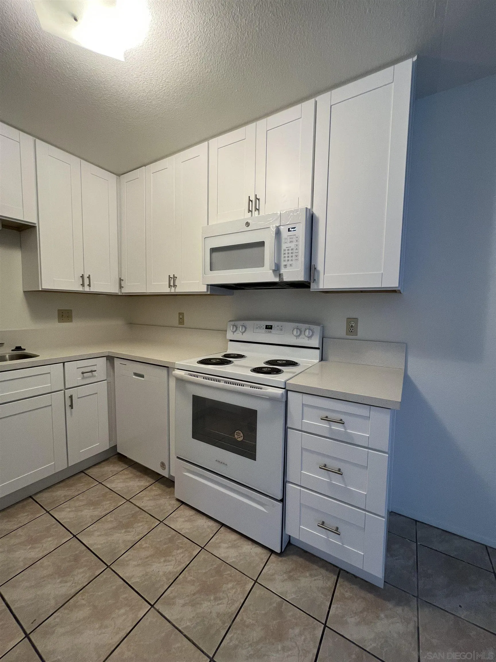 444 Bluffview Road Spring Valley, CA 91977 - Photo 26 of 34 a kitchen with cabinets appliances and a sink