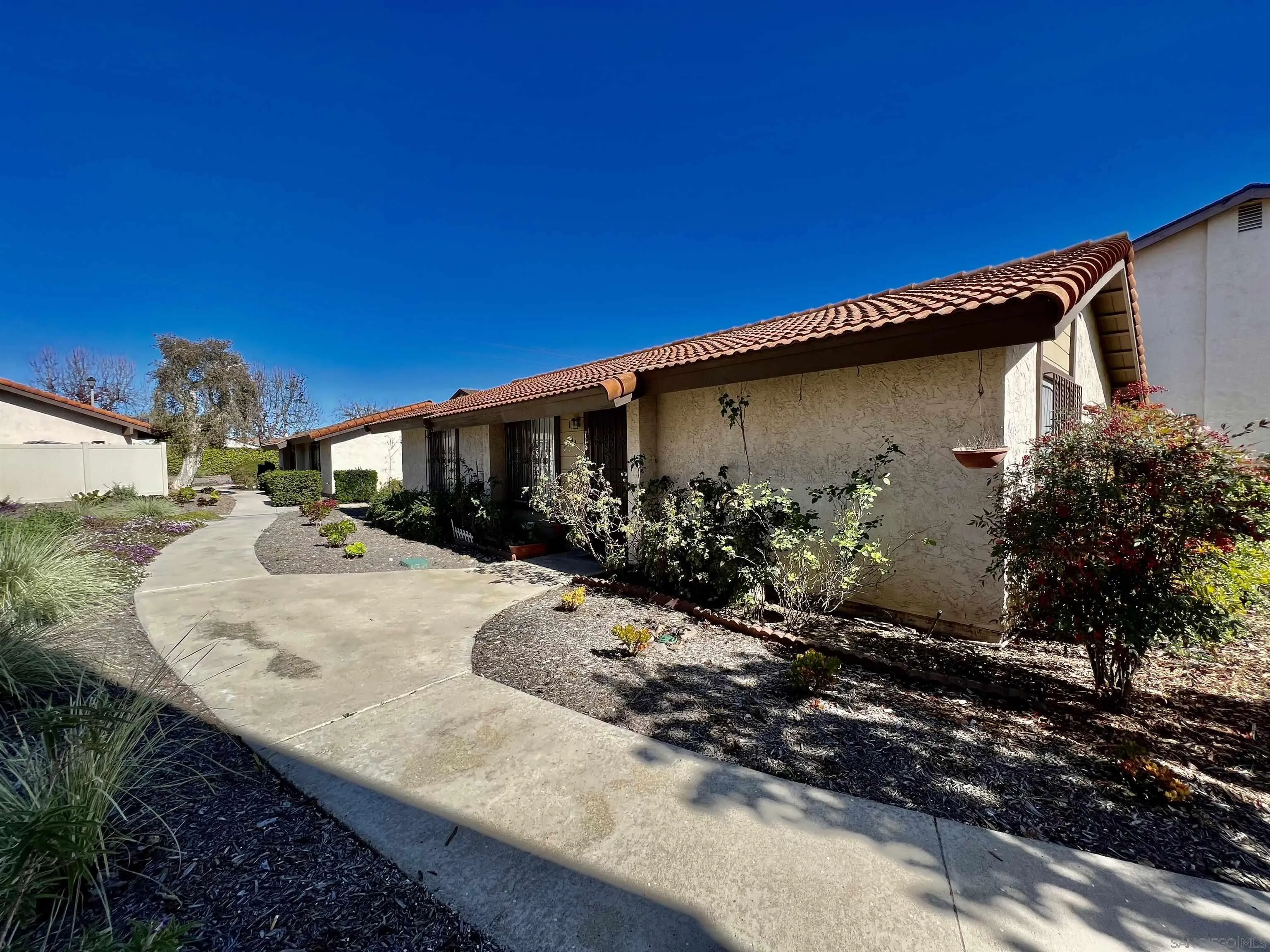444 Bluffview Road Spring Valley, CA 91977 - Photo 4 of 34 a backyard of a house with wooden fence and large trees
