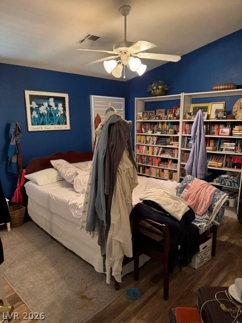 589 Beacon Ridge Way Mesquite, NV 89027 - Photo 13 of 18 Relax in this comfortable bedroom featuring a ceiling fan and convenient built-in shelving for storage.
