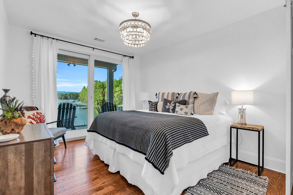 703 Cherokee Hill Road Hiawassee, GA 30546 - Photo 14 of 23 a spacious bedroom with a bed and a table