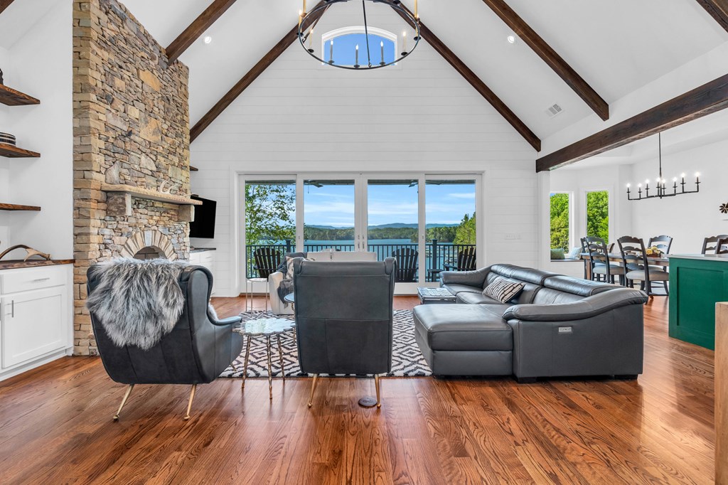 703 Cherokee Hill Road Hiawassee, GA 30546 - Photo 2 of 23 a living room with furniture a fireplace and a floor to ceiling window