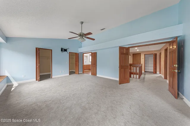 a view of a livingroom with a ceiling fan and window