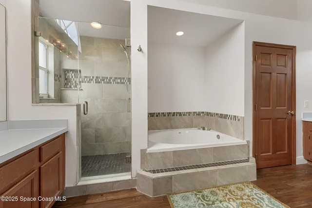 a bathroom with a tub shower and sink