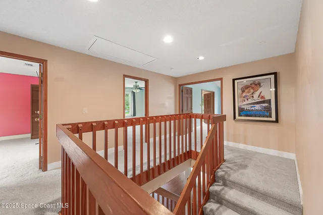 a view of staircase with furniture and a window