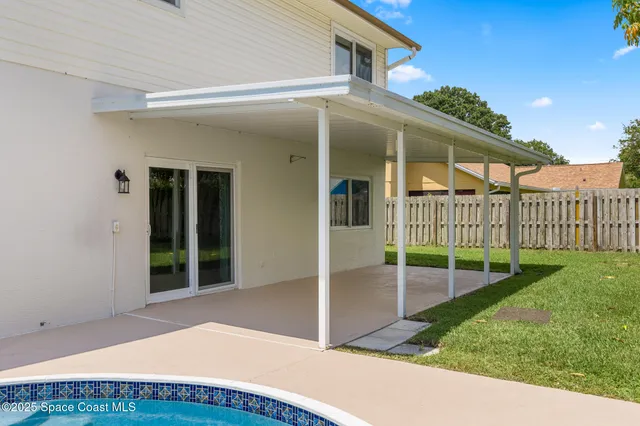 an aerial view of a house with outdoor space swimming pool