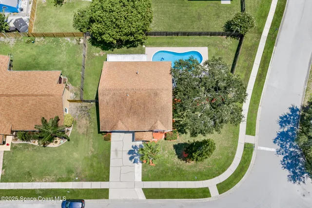 an aerial view of a house with a garden