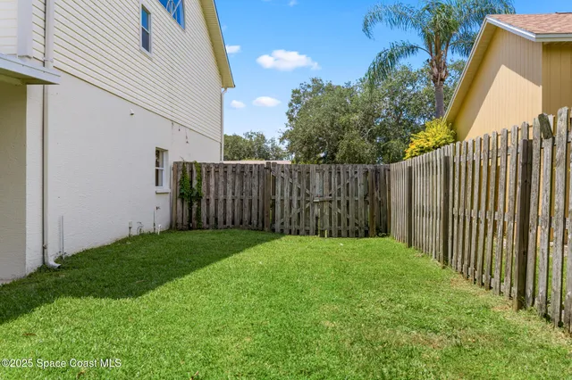 an aerial view of a house with a yard basket ball court and outdoor seating