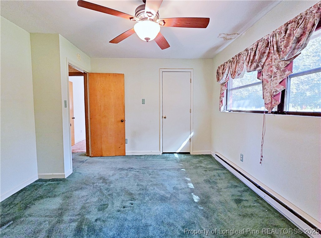 764 Old Vander Road Fayetteville, NC 28312 - Photo 23 of 50 an empty room with closet and a chandelier fan