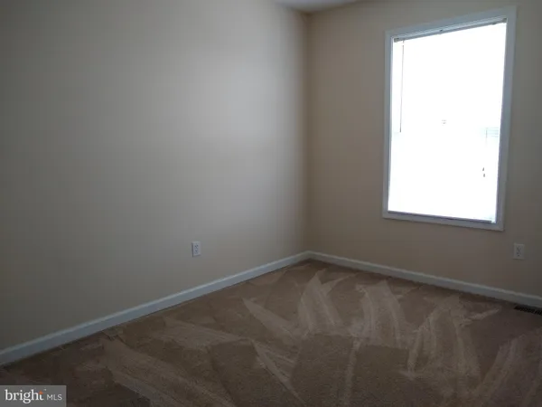 a bathroom with a granite countertop sink toilet and a mirror