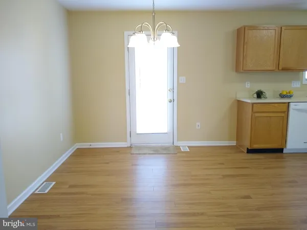 a view of a room with wooden floor and a sink