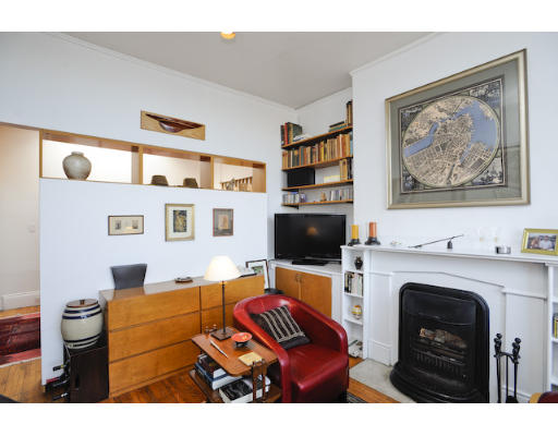 31 Pinckney Street, Unit 4B Boston, MA 02114 - Photo 3 of 5 a living room with furniture a fireplace and a flat screen tv