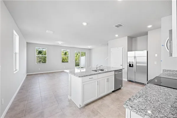a kitchen with a sink stove and refrigerator
