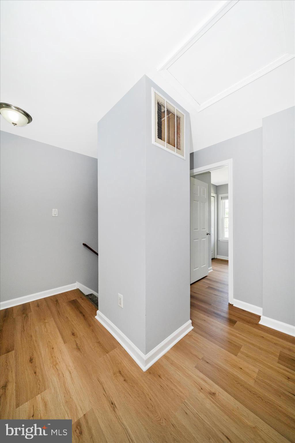 713 Seek Lane Silver Spring, MD 20912 - Photo 32 of 60 a view of a room with wooden floor and a hallway