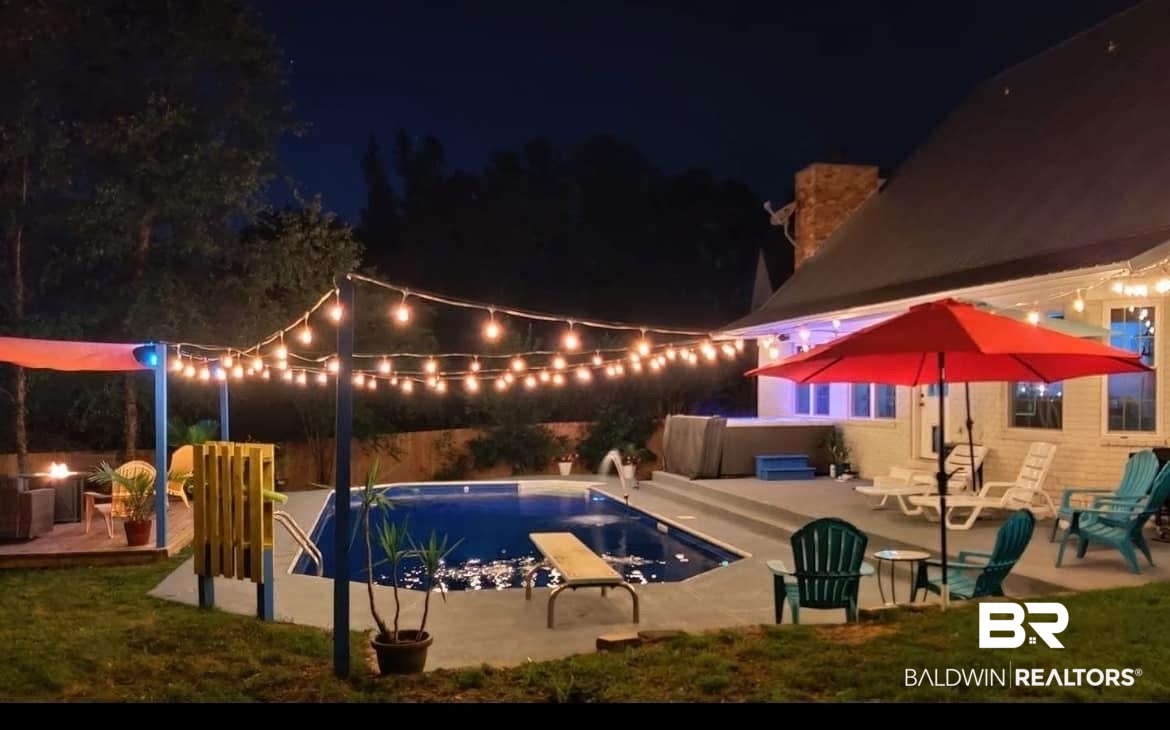 131 Marikesh Drive Daphne, AL 36526 - Photo 2 of 29 Pool at night with a diving board and a patio