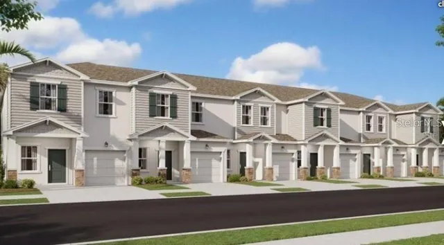 a front view of a residential apartment building with a yard