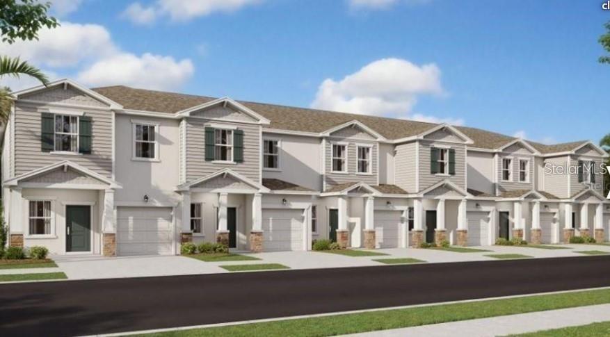 a front view of a residential apartment building with a yard