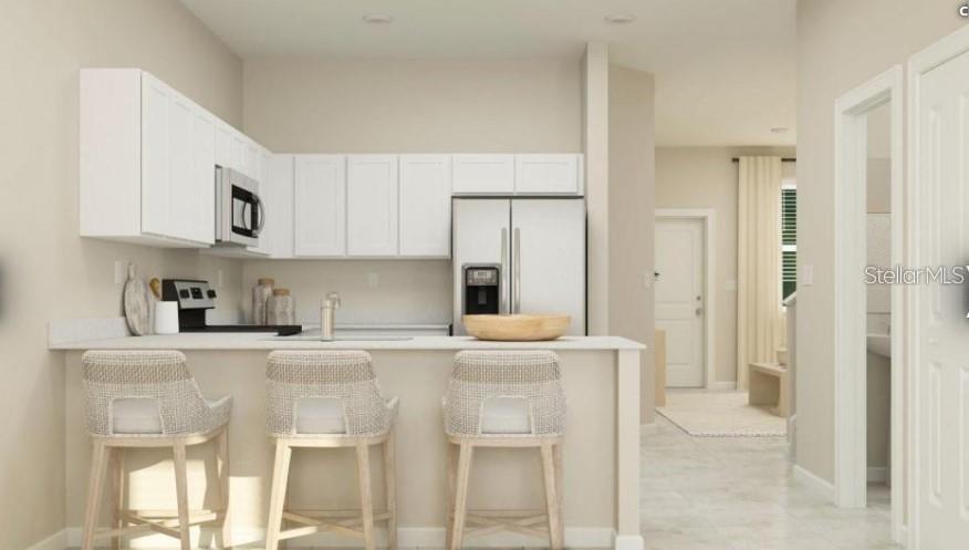 2667 Skyline Loop Kissimmee, FL 34758 - Photo 2 of 13 a kitchen with stainless steel appliances granite countertop a refrigerator and a stove top oven