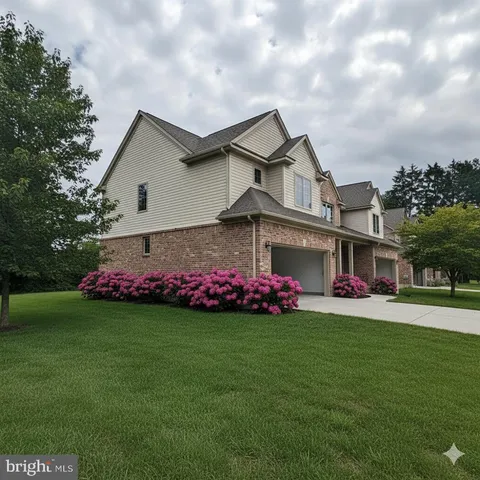 a front view of house with yard and garage
