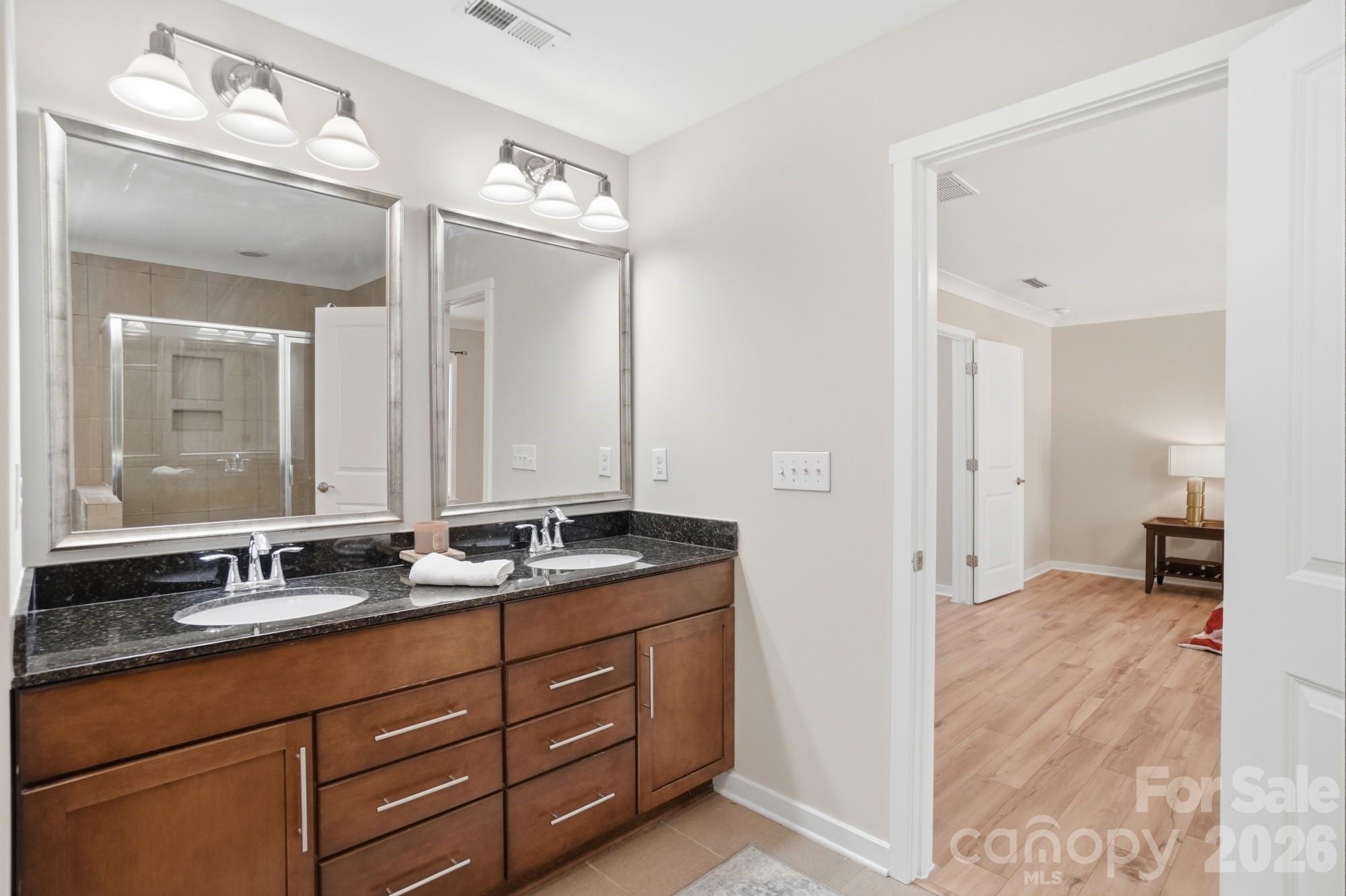 2153 Bluebell Way Tega Cay, SC 29708 - Photo 33 of 48 a bathroom with double vanity sinks and a mirror