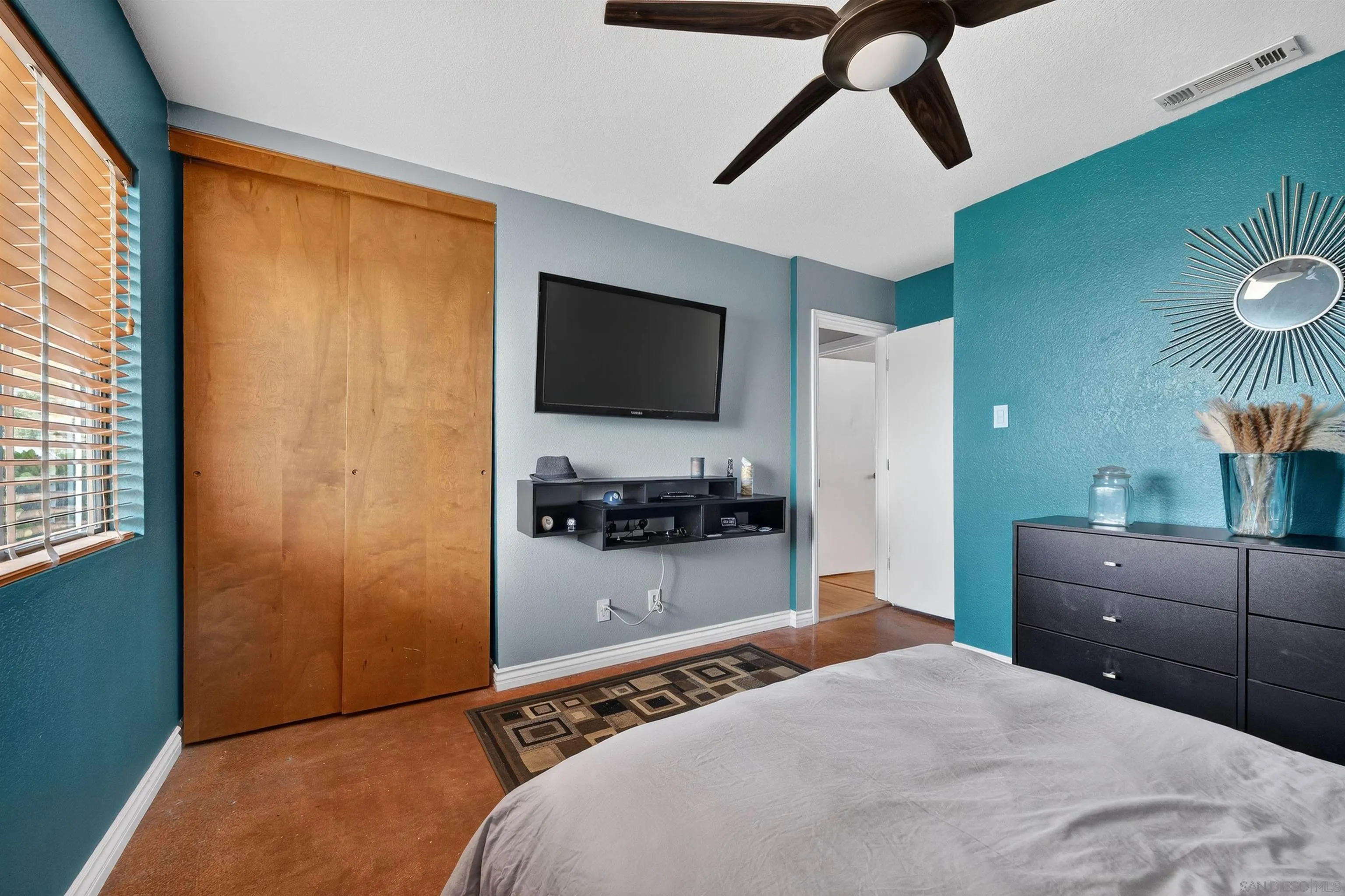 32721 Mountain View Road Bonsall, CA 92003 - Photo 17 of 33 a bedroom with a bed and a flat tv screen on dresser