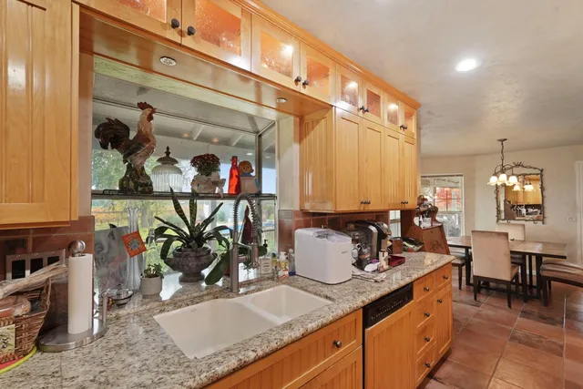 a room with furniture a chandelier and a window