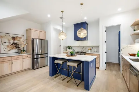 a kitchen with a sink appliances and cabinets
