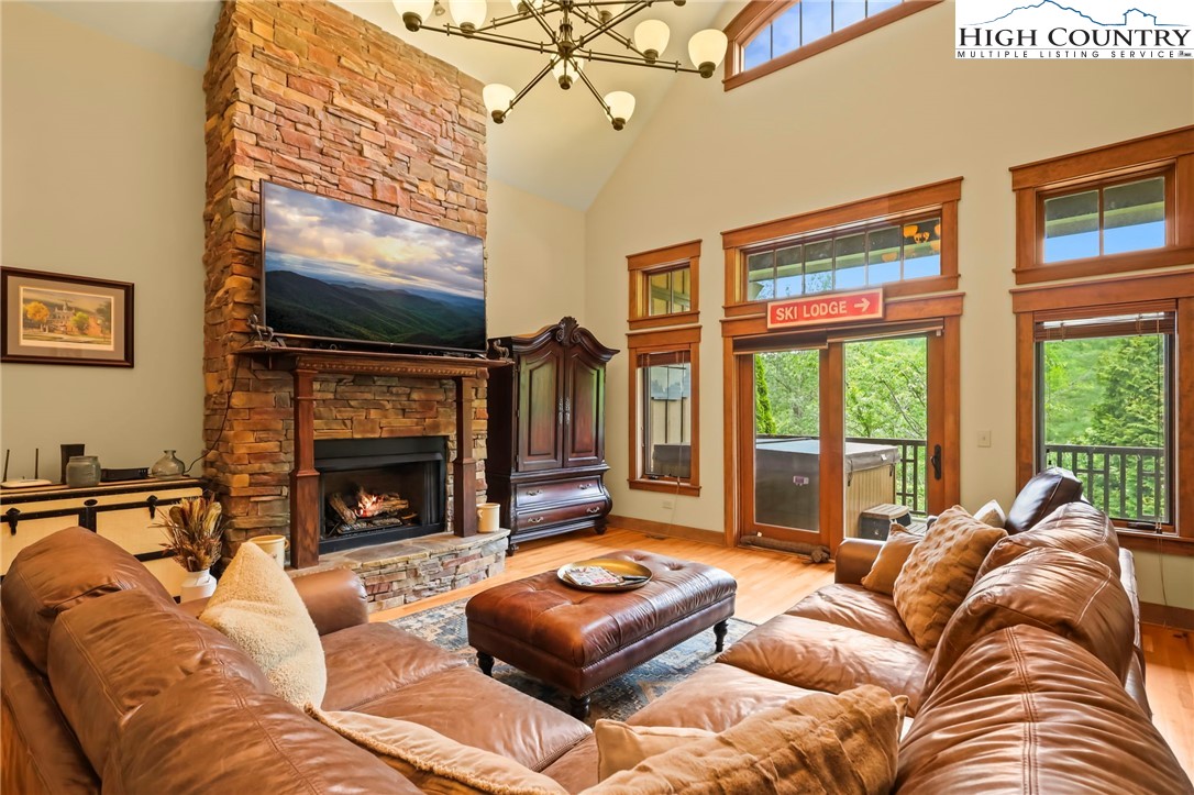 138 South Camp Road, Unit 103 Boone, NC 28607 - Photo 16 of 50 a living room with furniture a flat screen tv and a fireplace