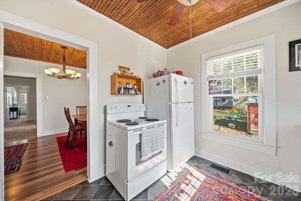 a kitchen with stainless steel appliances granite countertop a refrigerator and a stove