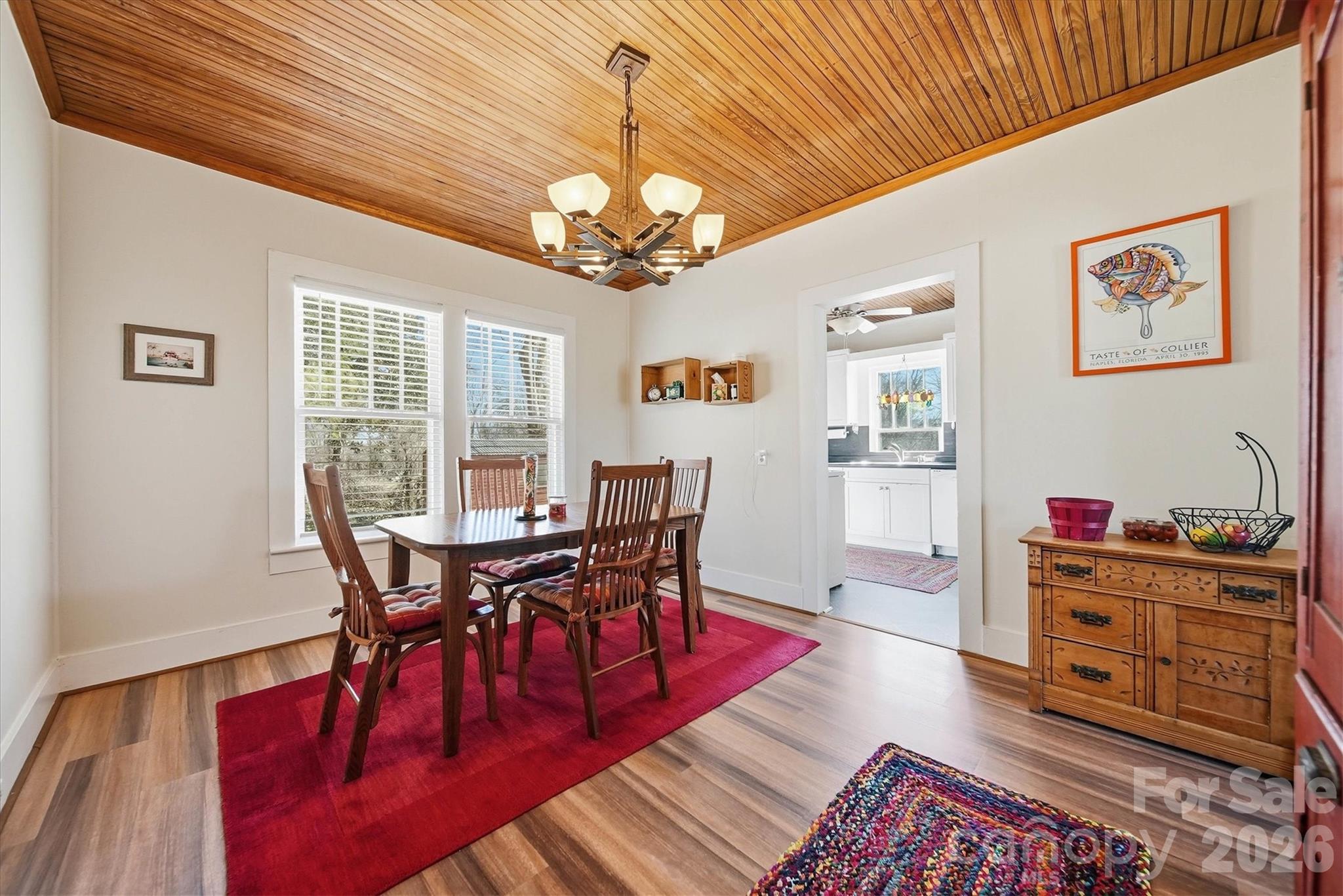 113 Leonhardt Road Morganton, NC 28655 - Photo 13 of 44 a view of a dining room with furniture a chandelier and wooden floor